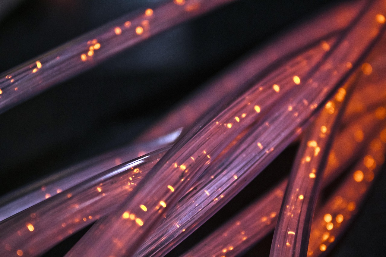 Fiber optic cables with glowing light signals showing high-speed connectivity